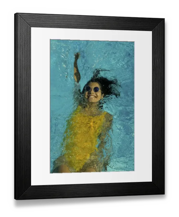 Framed Print : Young woman swimming in swimming pool