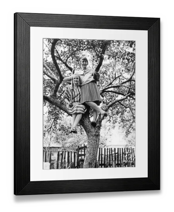 Framed Print : Two women with gun sitting on a tree in the garden Framed Print : Two women with gun sitting on a tree in the garden