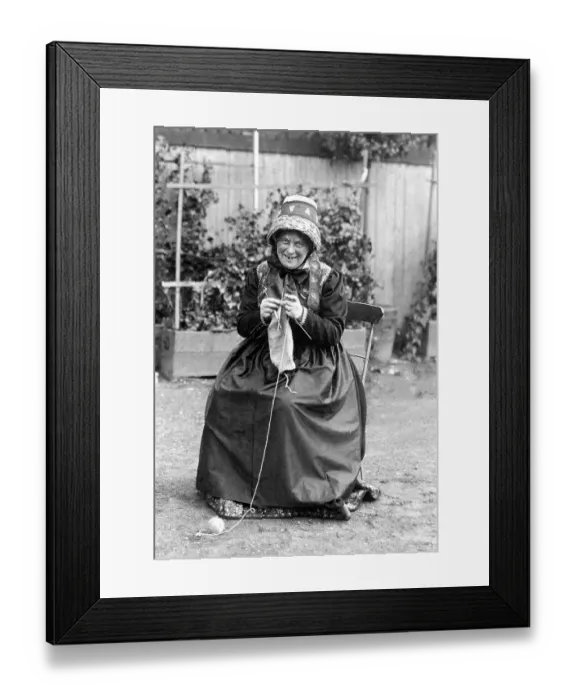 Framed Print : Old Woman knitting in Traditional Costume