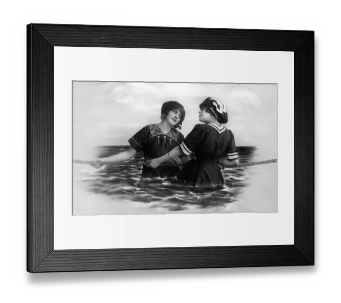 Framed Print : Two women pulling a rope in the sea