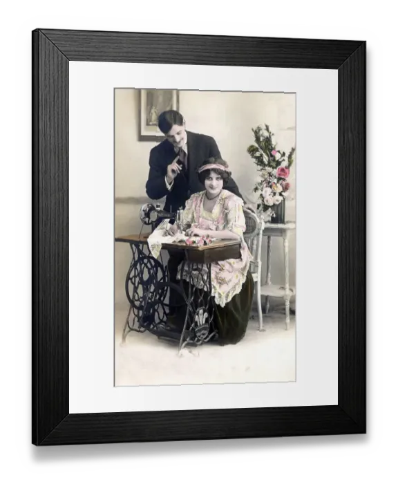 Framed Print : Lovers flirting, woman sitting at the sewing machine