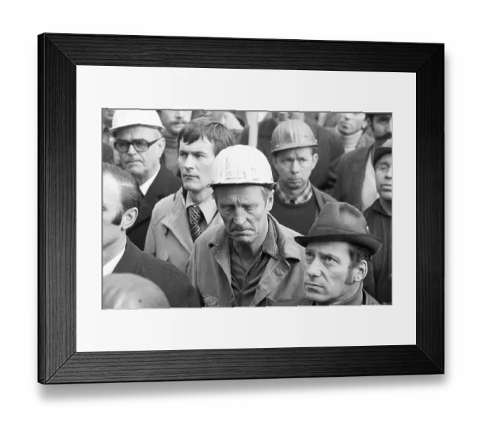 Framed Print : The concern for their jobs is written all over the faces of the workers Framed Print : The concern for their jobs is written all over the faces of the workers