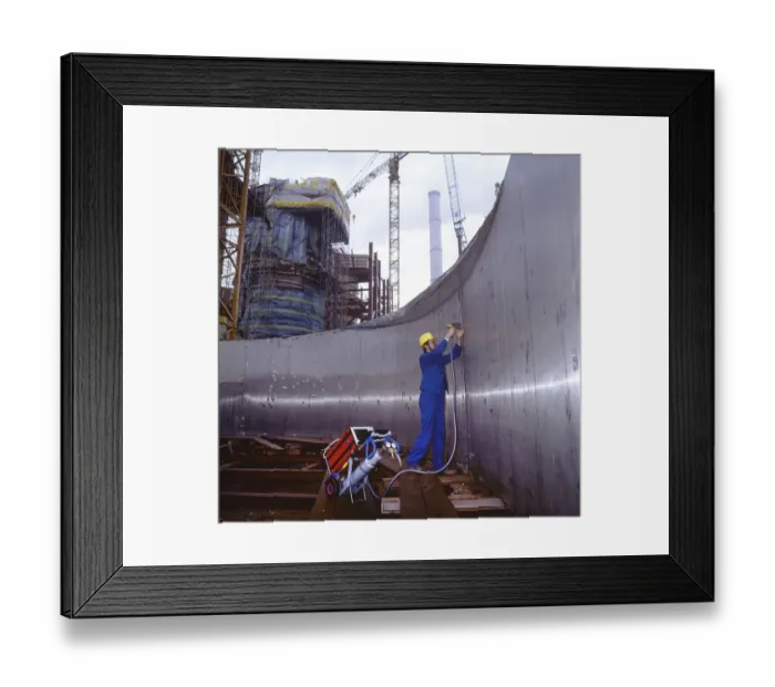 Framed Print : Workmen building a coal-fired power plant