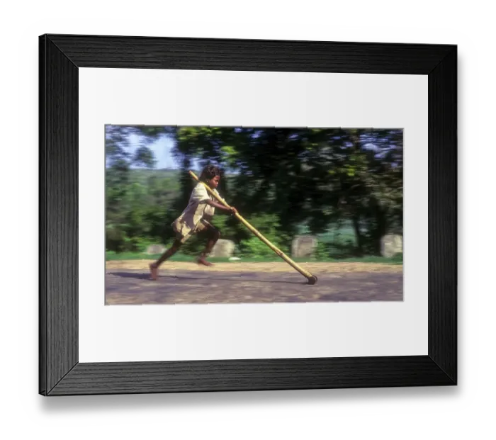 Framed Print : Panning, tribal boy playing improvised pulley in balle