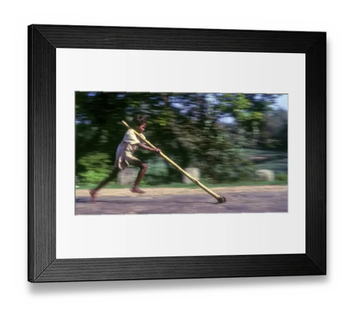 Framed Print : Panning, Tribal boy playing improvised pulley in balle