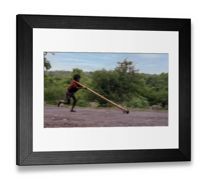 Framed Print : Panning, Tribal boy playing improvised pulley in balle