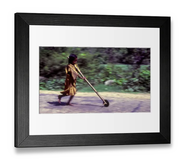Framed Print : Panning, Tribal girl child playing improvised pulley in balle