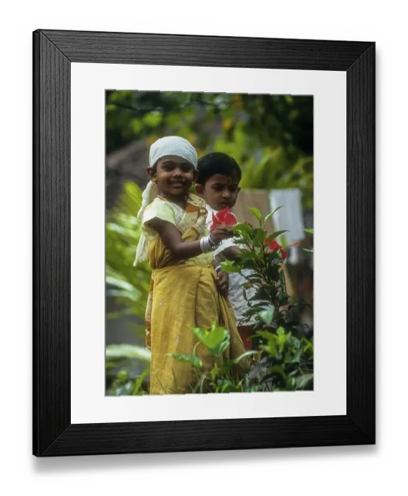Framed Print : A girl child holding (Hibiscus) flower