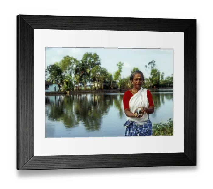 Framed Print : A woman holding freshly caught fish Framed Print : A woman holding freshly caught fish