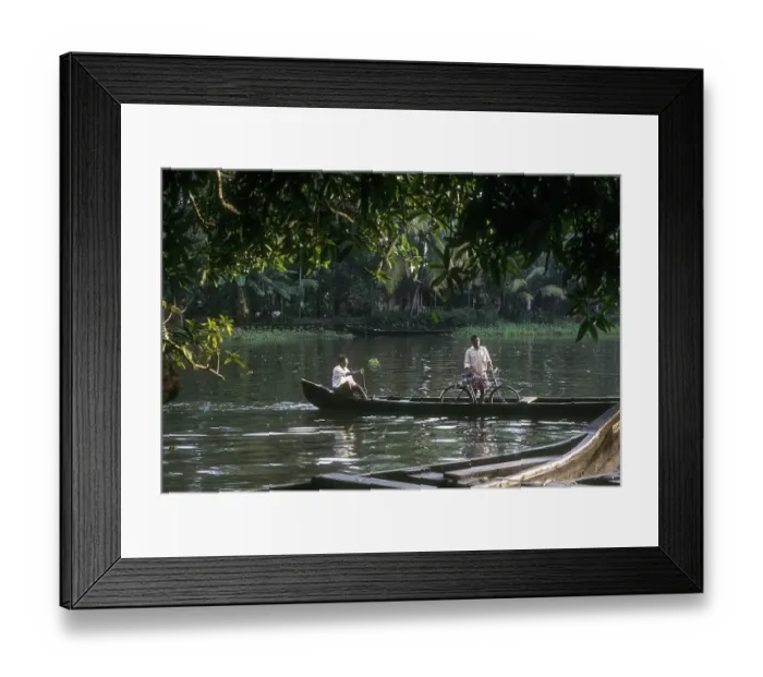 Framed Print : A man crossing the backwater with bicycle Framed Print : A man crossing the backwater with bicycle
