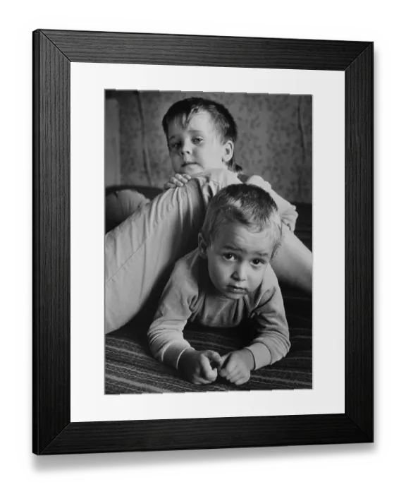 Framed Print : Children playing at their mother's leg
