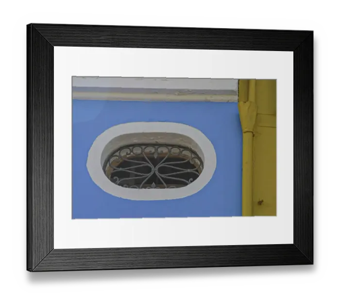Framed Print : Oval window on blue-yellow house wall Framed Print : Oval window on blue-yellow house wall