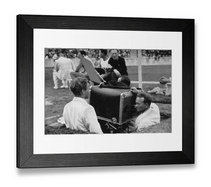 Framed Print : The film operator shoots the big Olympic film in the pit with the giant camera