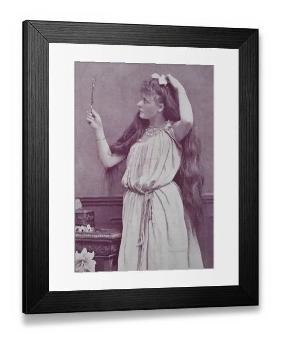 Framed Print : Girl with very long hair looks in a hand mirror Framed Print : Girl with very long hair looks in a hand mirror