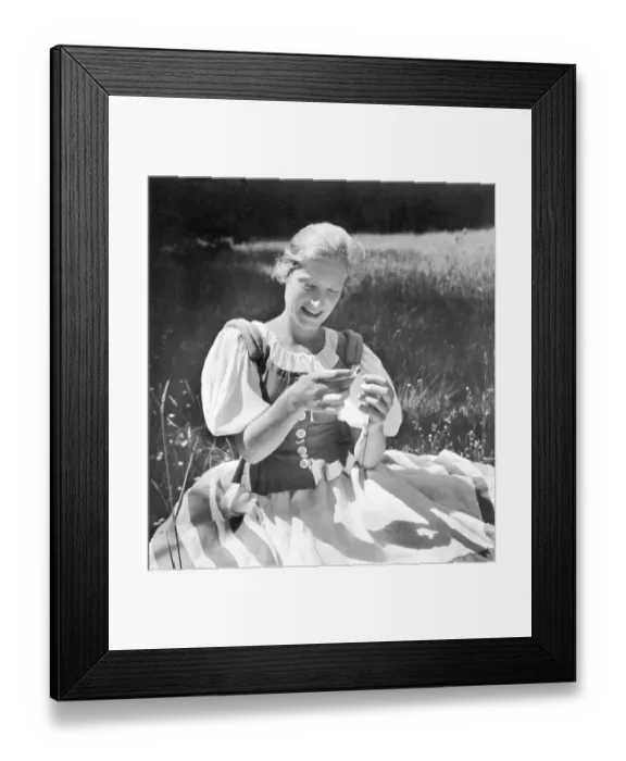 Framed Print : Historic photo, woman plucking petals, ca. 1940