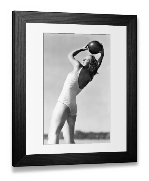 Framed Print : Historical image, woman holding a ball, ca. 1940