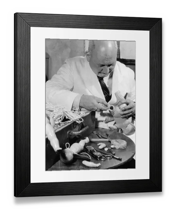 Framed Print : Historic photograph, man repairing dolls Framed Print : Historic photograph, man repairing dolls