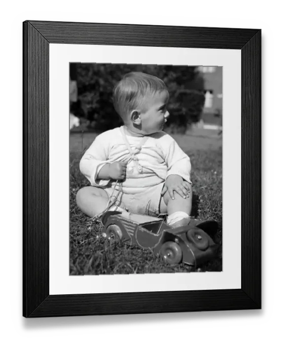 Framed Print : Historic photograph, small boy playing with a wooden car