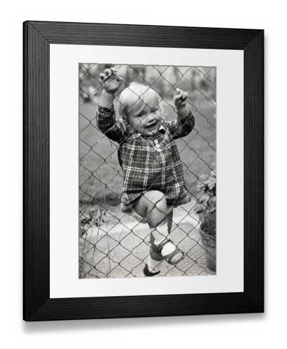 Framed Print : Historic photograph, small girl climbing a fence