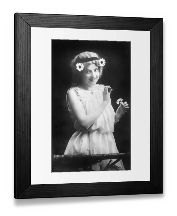 Framed Print : Woman pulling petals from a flower Framed Print : Woman pulling petals from a flower