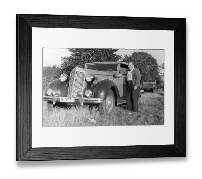 Framed Print : Small man, large car, historic photograph