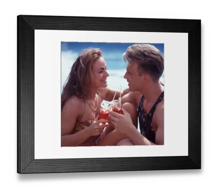 Framed Print : Young couple drink by the pool