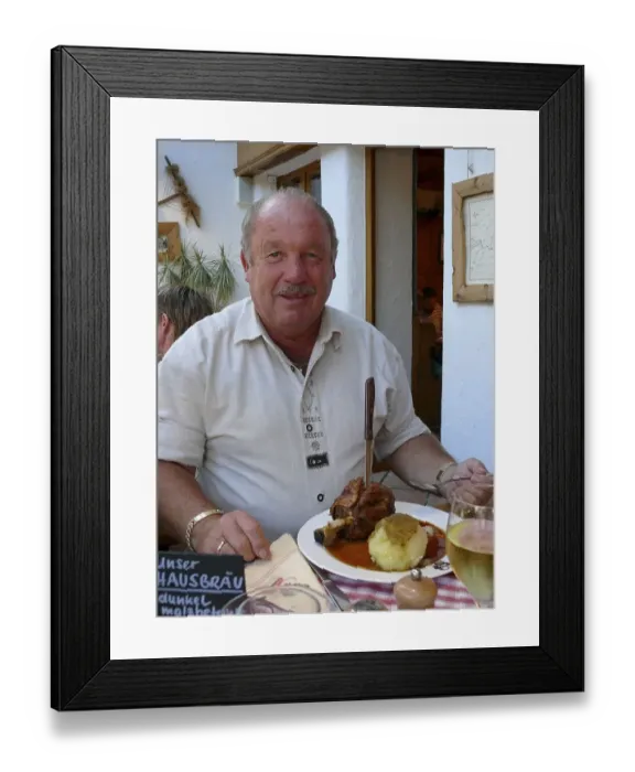 Framed Print : Man with knuckle of pork and dumplings