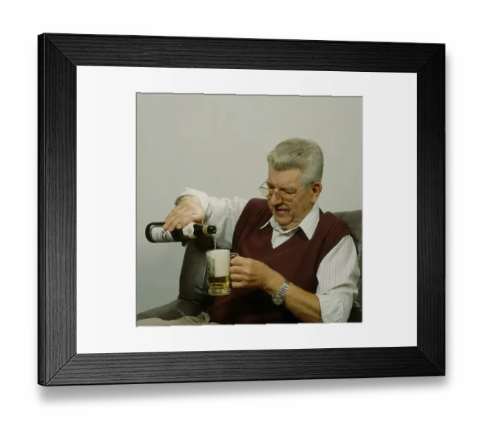 Framed Print : Older man pours beer into glass