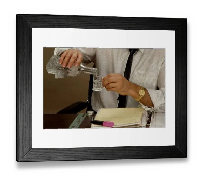 Framed Print : Man drinks liquor in the office