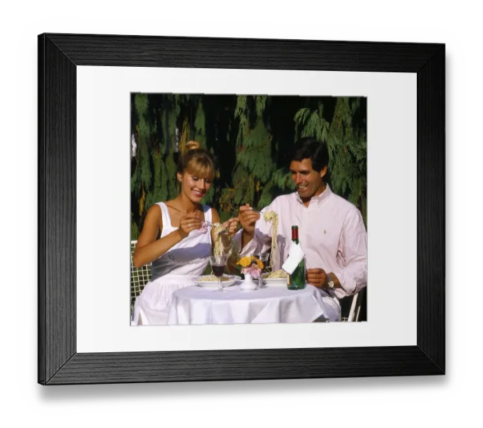 Framed Print : Couple eating spaghetti on terrace Photo