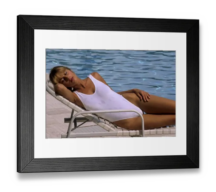 Framed Print : Young woman at the swimming pool, sunbathing