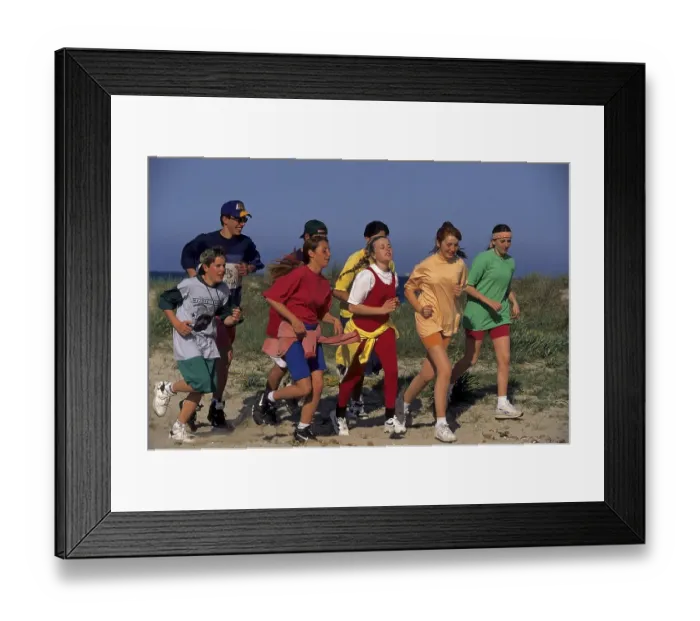 Framed Print : Young people jogging on the beach, group