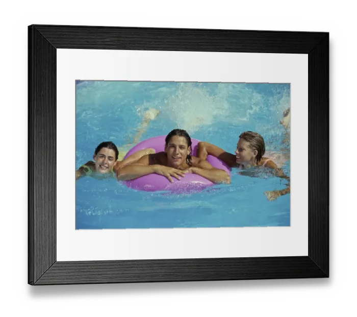 Framed Print : 3 young woman in the water, 1 woman with swimming ring