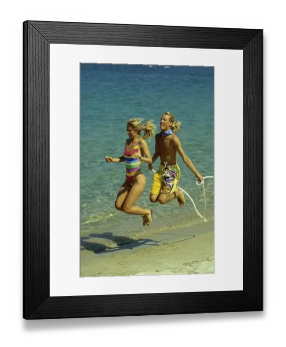Framed Print : Couple on the beach, beach running and jumping rope
