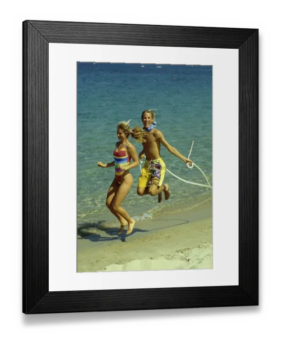Framed Print : Couple on the beach, beach running and jumping rope