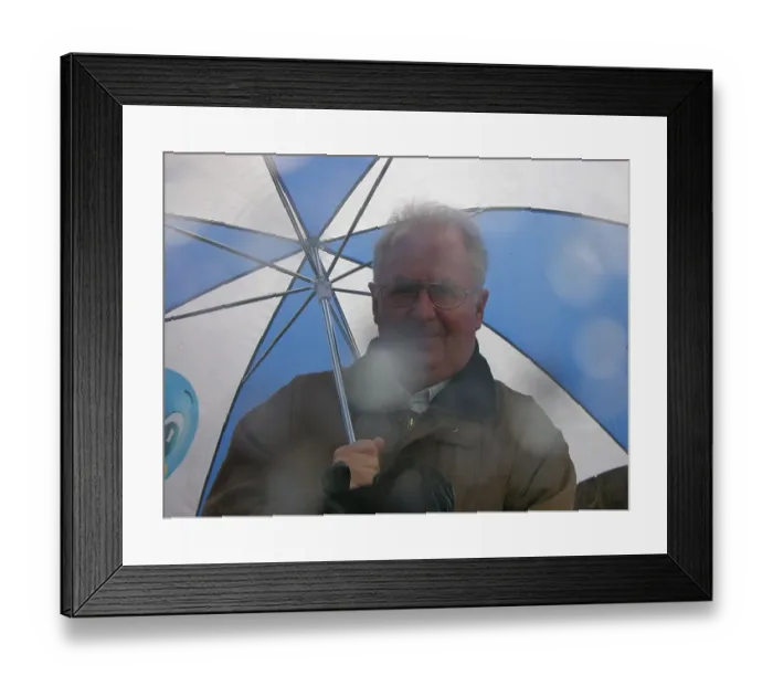 Framed Print : Man in the rain under an umbrella Framed Print : Man in the rain under an umbrella