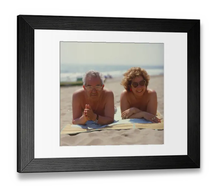 Framed Print : Older married couple on the beach