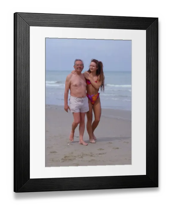 Framed Print : Older man flirts with young woman on the beach Framed Print : Older man flirts with young woman on the beach