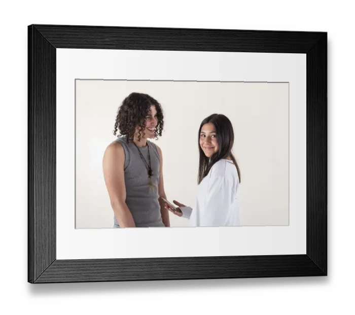 Framed Print : Portrait of a young couple dressed in yoga clothes laughing over white background