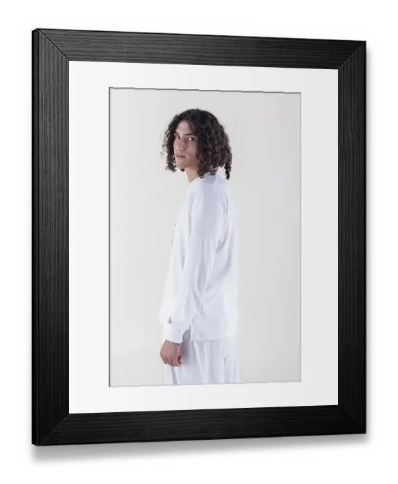 Framed Print : Portrait of a young man dressed in white yoga clothes over white background while looking at camera Framed Print : Portrait of a young man dressed in white yoga clothes over white background while looking at camera
