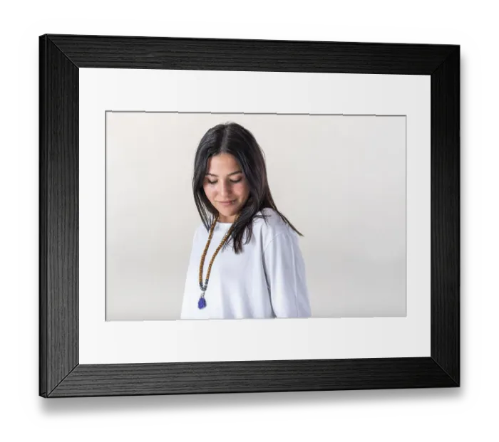 Framed Print : Portrait of a young woman dressed in white yoga clothes over white background wearing a japa mala
