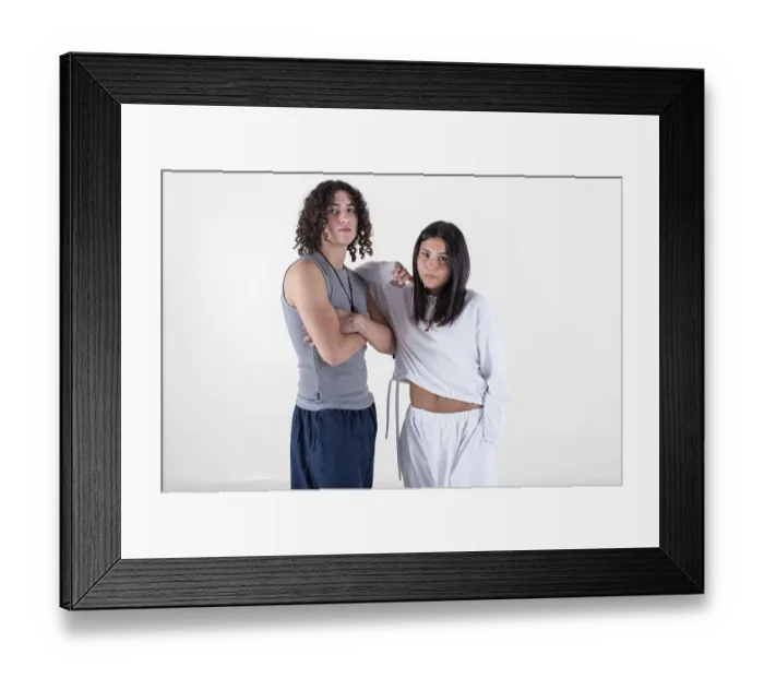 Framed Print : Portrait of a young couple dressed in yoga clothes looking ti the camera white background Framed Print : Portrait of a young couple dressed in yoga clothes looking ti the camera white background