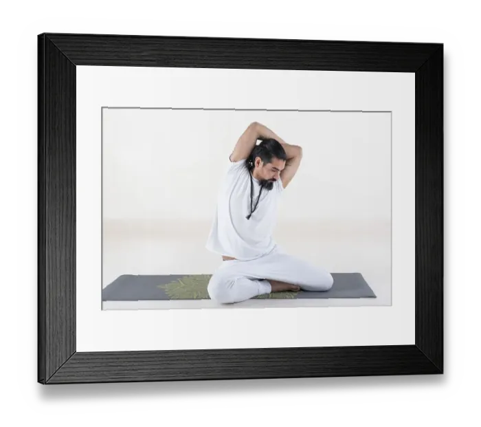Framed Print : A man dressed in white doing yoga on a mat over white background