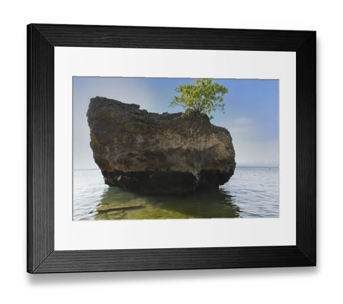 Framed Print : A large rock on the shore on a sunny day in Padang Padang Beach