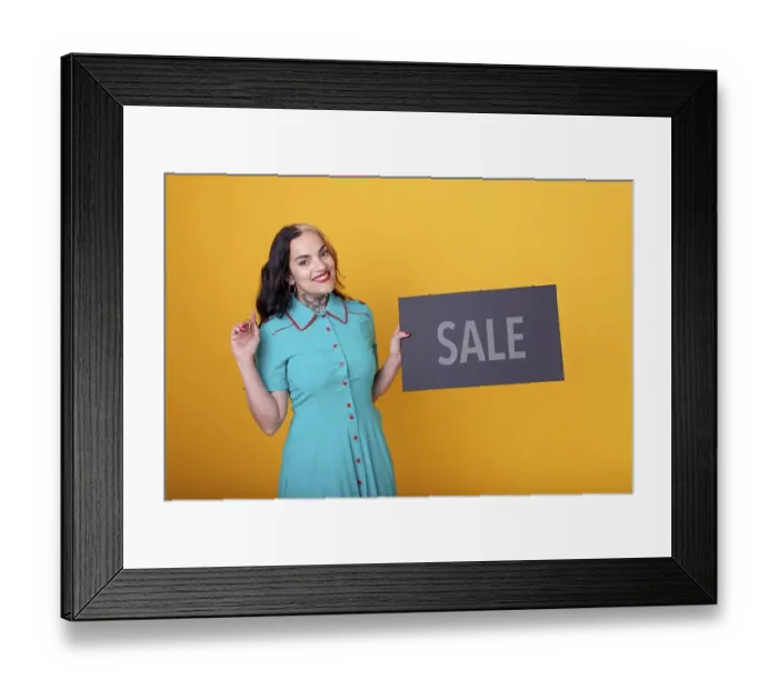 Framed Print : Beautiful woman holding a Sale sign