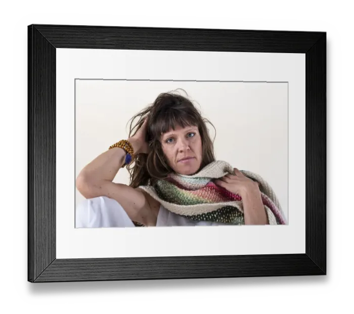 Framed Print : Portrait of a serious woman looking at camera over a white background