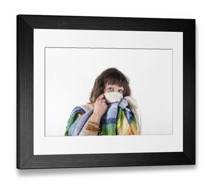 Framed Print : Woman looking at camera while putting her scarf over her mouth Framed Print : Woman looking at camera while putting her scarf over her mouth