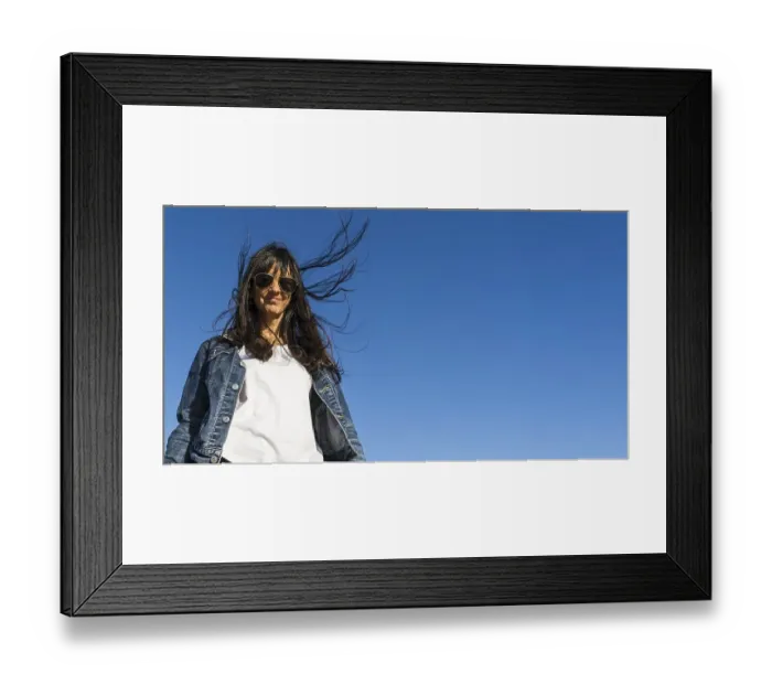 Framed Print : Low angle view of a similing woman outdoors
