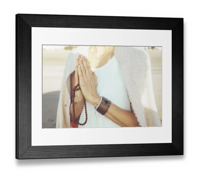 Framed Print : Close up of a woman clasping hands while holding a japa mala outdoors