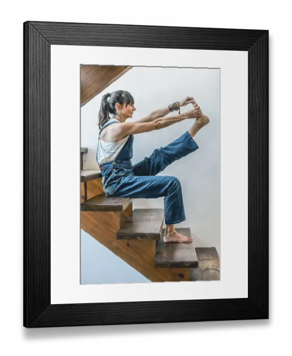 Framed Print : A woman doing stretching exercises on the stairs of her home